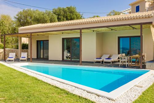 een villa met een zwembad en een huis bij FRG Villas - Villa Volare in Kefallonia