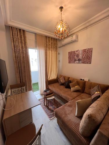 a living room with a couch and a table at Appartement L'aouina cité wahat in Tunis
