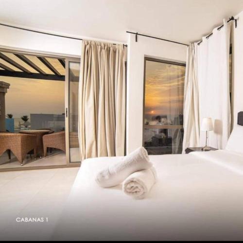 a bedroom with a bed with two towels on it at Rose Beach Chalet in Aqaba