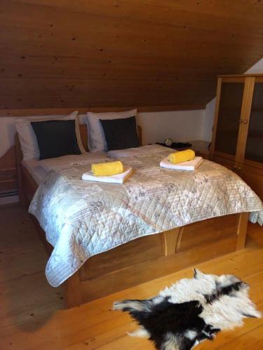 a bedroom with a bed with two towels on it at Apartma ČVRSTA TROJKA in Jesenice