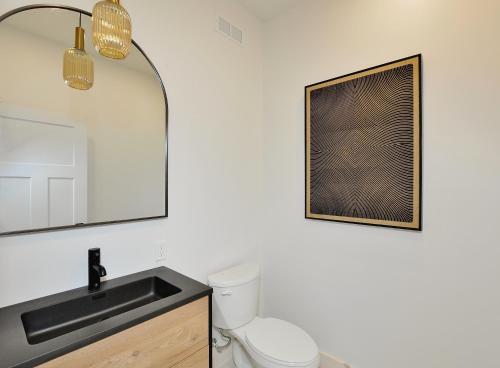 a bathroom with a toilet and a sink at 32 Chemin Blanc in Stoneham