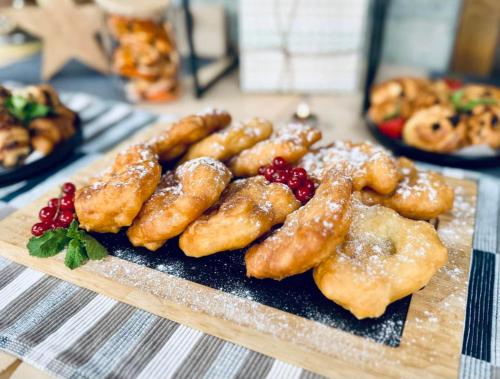 um monte de doces em um prato de madeira sobre uma mesa em BOUTIQUE Hotel ENTRY E em Bansko