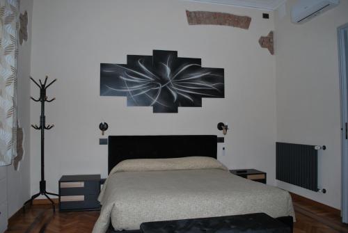 a bedroom with a bed with a flower on the wall at CASA RITA e CASA LUIGI in Turin