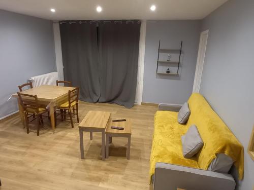 a living room with a couch and a table at Le Spacieux, Tendance et sa Vue Panoramique in Beauvais