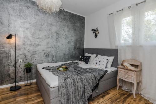 a bedroom with a bed with a blanket on it at Francesca Apartment in Bibinje