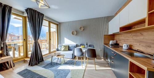 a kitchen with a table and chairs in a room at BOUTIQUE Hotel ENTRY E in Bansko