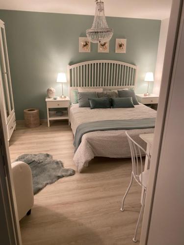 a bedroom with a bed and two tables and two lamps at B&B Nathalie in Quartino