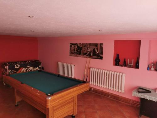 einen Billardtisch in einem Zimmer mit roten Wänden in der Unterkunft Usługi Noclegowe i Gastronomiczne dla Ludności Robert Mielcarek in Kobyla Góra