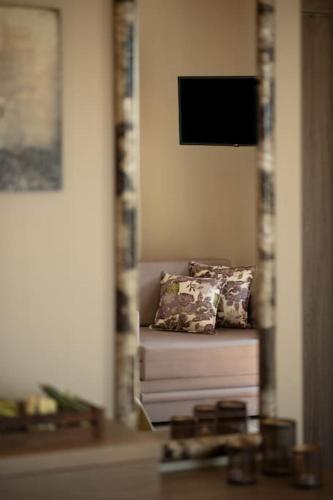 a couch with two pillows in a living room at Infinity blue villa in Nikiti