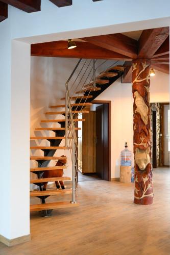 a spiral staircase in a room with a stone pillar at Chata Exit in Kolonica