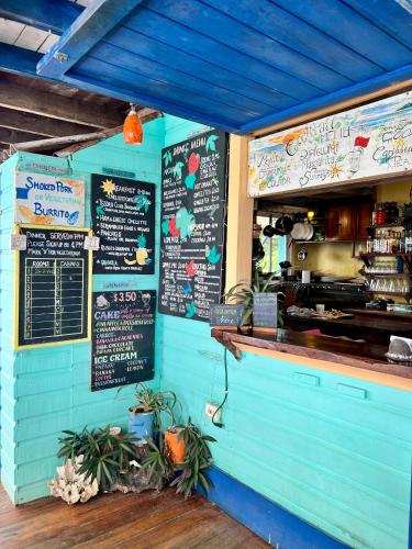 a restaurant with a blue wall with signs on it at Tesoro Escondido Ecolodge Cabinas in Bocas del Toro
