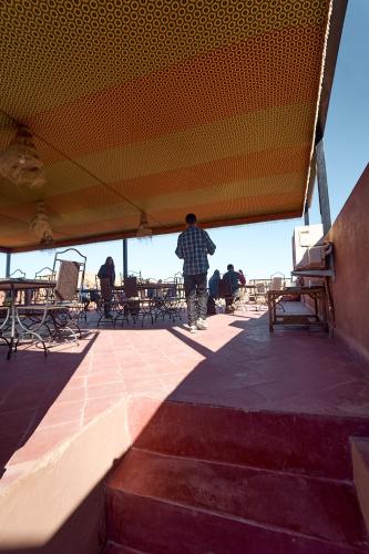 a man standing under a tent on a patio at Chez Brahim vue panoramique in Aït Ben Haddou
