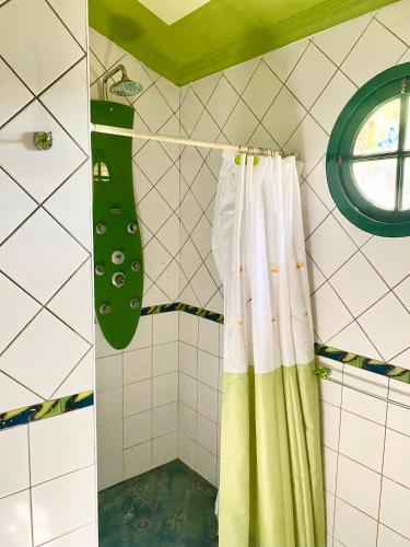a shower with a green and white shower curtain at Cabañas El Naranjo in San Rafael
