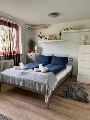 a bedroom with a large bed with blue pillows at Cozy apartment in Ljubljana - Free parking in Ljubljana