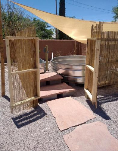 a pair of wooden doors in front of a pool at Casita De Agua Encanto in Truth or Consequences