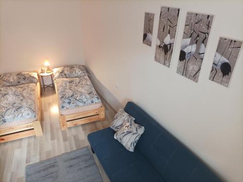 a living room with two beds and a blue couch at U kapličky, Boskovice in Boskovice