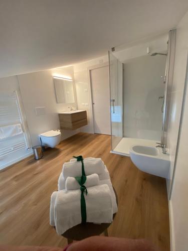 a white bathroom with a sink and a toilet at Kalé in Pordenone