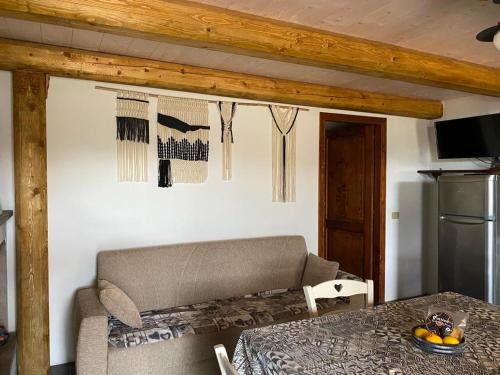 a living room with a table and a couch and a table and a table at Casa Margherita in Càbras