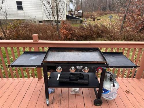 a stove sitting on top of a deck at Home sweet home in woods in Tobyhanna