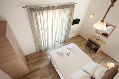 a white room with a table and a desk at Petra Thea in Kalamata