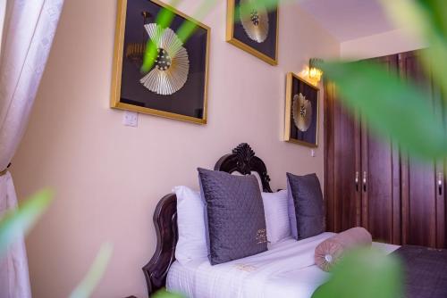 a living room with a couch and pictures on the wall at Glamour Suites in Nanyuki