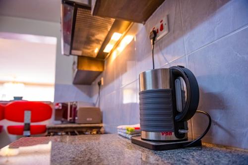 a coffee maker sitting on top of a kitchen counter at Glamour Suites in Nanyuki