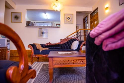 a living room with a couch and a coffee table at Glamour Suites in Nanyuki