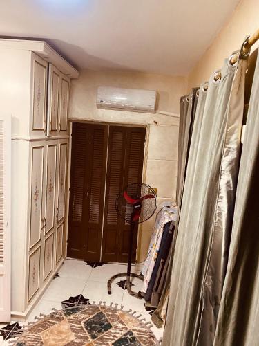 a room with a window and a fan in a room at LuXury Apartment Nasr City - CityStars in Cairo