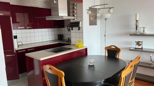 a kitchen with a black table and chairs in it at Rheinblick Neuss - Düsseldorf in Neuss
