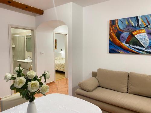 a living room with a couch and a painting on the wall at Sanja apartments Sveti Servul in Novigrad Istria