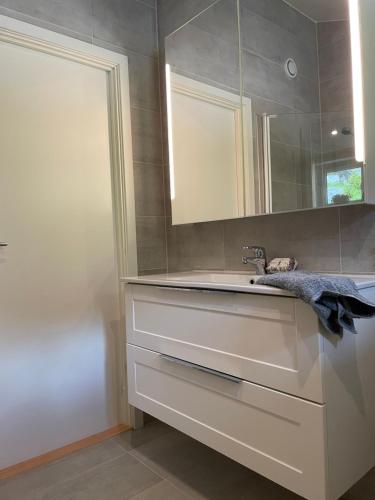 a bathroom with a sink and a mirror at Cabin near Pulpit Rock in Strand