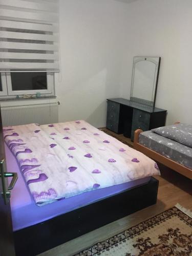 a bedroom with a bed and a dresser and a mirror at Apartman Marija in Kupres
