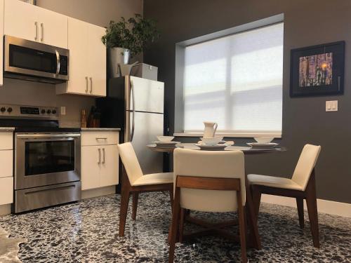 a kitchen with a table with chairs and a refrigerator at Petaluma Warehouse Lofts, Unit B in Petaluma