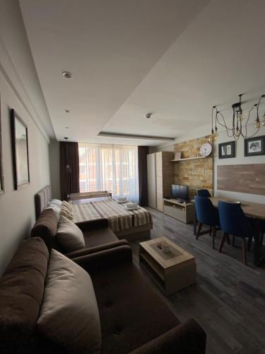 a large living room with a couch and a table at Milmari Premier 28 Kopaonik in Kopaonik
