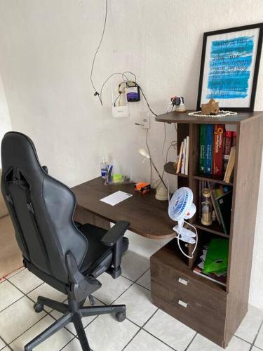a desk with a chair and a computer on it at Casa de Dandá in Porto Seguro