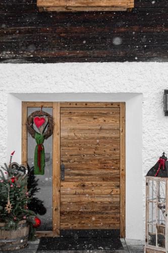 a door to a house with a christmas ornament at Peer Alm in Navis