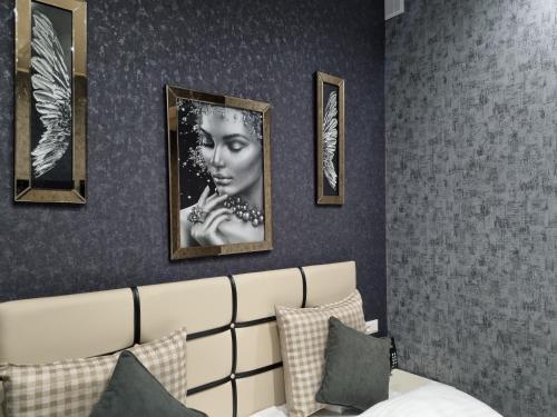 a bedroom with pictures of a woman on the wall at Dayssin Boutique hotel in Yerevan