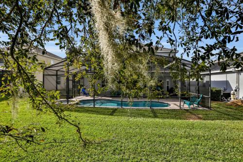 a house with a swimming pool in a yard at Themed Luxury 6BR Getaway with Resort Amenities in Orlando