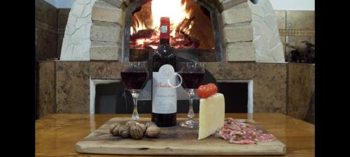 a bottle of wine and two glasses on a table at Vila Decebal in Râşnov