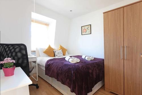 a bedroom with a bed and a desk and a cabinet at Lovely Private Bedrooms in Euston, Central London in London