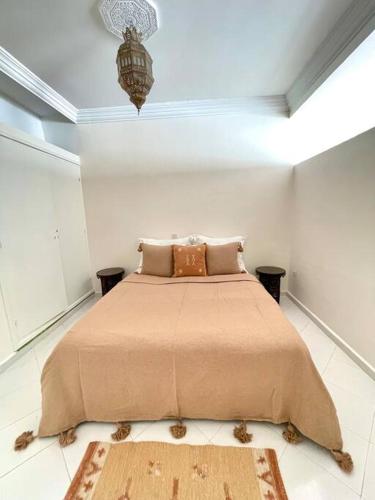 a bedroom with a large bed in a white room at Dar Mustapha in Sidi Ifni