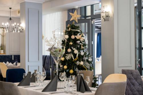 a christmas tree in the middle of a dining room at Aquamarine - Beach & SPA Hotel- All inclusive in Kranevo