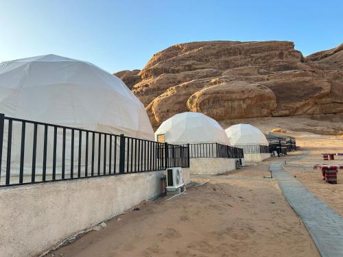 two domed observatories in front of a mountain at wadi rum caeser camp in Wadi Rum