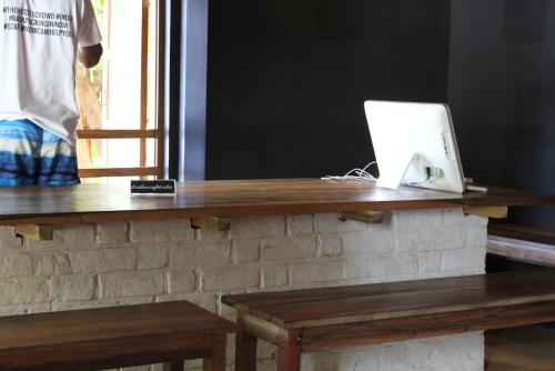 a laptop computer sitting on top of a wooden table at The Old Quarter Hostel in Panaji