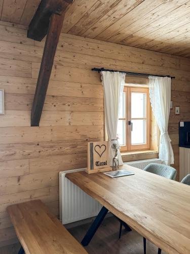 a wooden room with a table with a box with a heart on it at Peer Alm in Navis