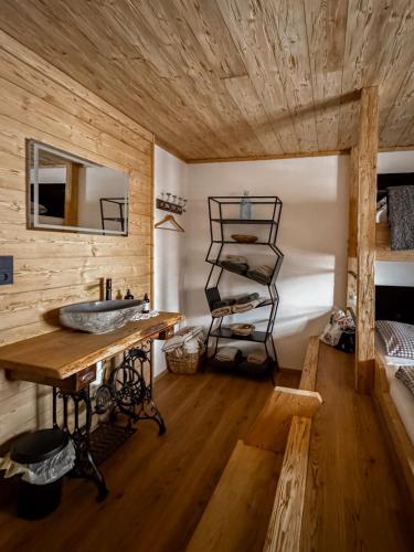 a bathroom with a sink and a wooden wall at Peer Alm in Navis