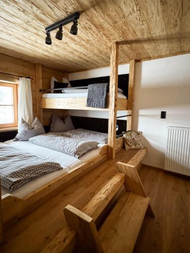 a bedroom with two bunk beds in a cabin at Peer Alm in Navis