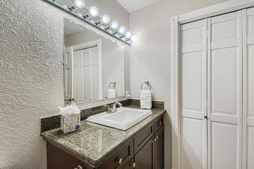 a bathroom with a sink and a mirror at Quiet Efficiency Condo - Downtown Minneapolis in Minneapolis