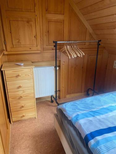a bedroom with a bed and a dresser at Ferienwohnung im Herzen Tribergs in Triberg