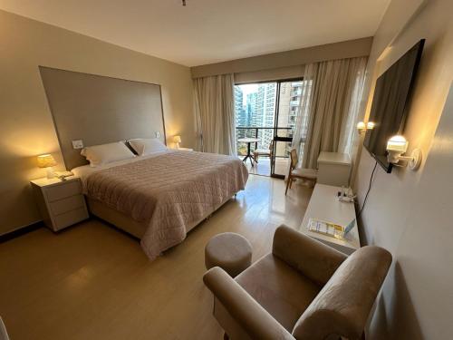 une chambre d'hôtel avec un lit et un canapé dans l'établissement Kubitschek Plaza Hotel - Flat Particular 2, à Brasilia